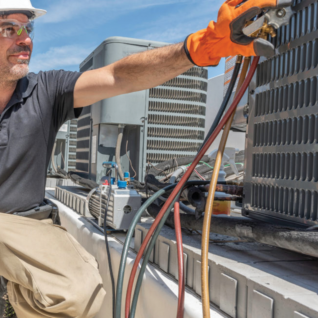 HVAC specialist performing maintenance on an air conditioning unit